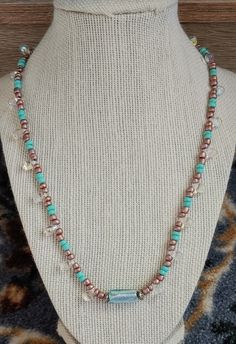 This necklace is made with metallic teardrop beads, teal seed beads, gold seed beads, and a teal oblong bead in the middle. Toggle clasp. Measures 20 inches long end to end. Baseball Necklace, Blue Beaded Earrings, Fish Necklace, Starfish Necklace, Teardrop Beads, Teardrop Necklace, Beaded Necklaces, Toggle Clasp, In The Middle