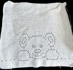 a white crocheted bag with the word love written in black ink on it