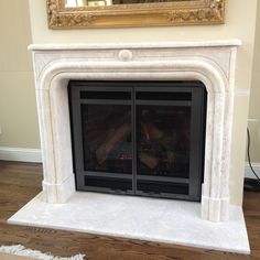 a fireplace with a painting on the wall above it