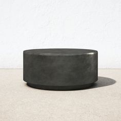 a concrete planter sitting on top of a cement floor next to a white wall