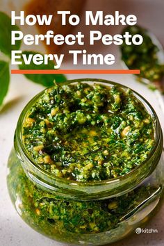 a jar filled with pesto sauce on top of a table