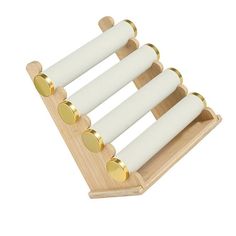 a wooden rack with four white candles on it