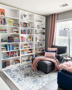 a living room filled with furniture and bookshelves