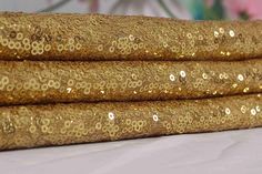 three gold sequins are stacked on top of each other