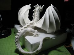 a white dragon sculpture sitting on top of a table