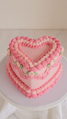 a heart shaped cake sitting on top of a white plate