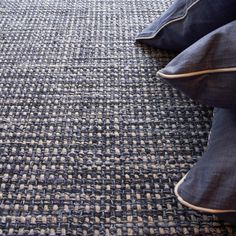 a blue rug with two pillows on it