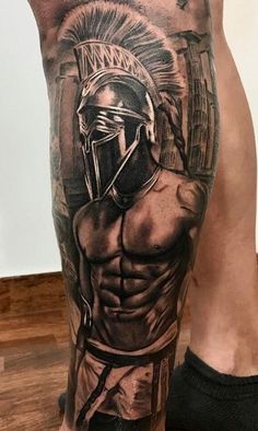 a man with a spartan tattoo on his leg