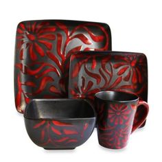 a red and black dinnerware set on a white background with an artistic design in the middle