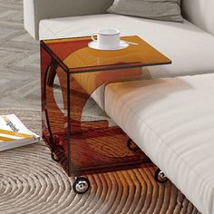 a coffee table with a magazine on it next to a couch