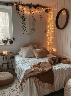 a bedroom with white walls and string lights