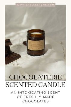 a candle that is next to some chocolates