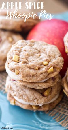 apple spice whoopie pies stacked on top of each other with apples in the background