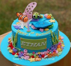 a blue birthday cake with fish and sea creatures on it