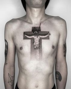 a man with tattoos on his chest has a cross tattoo on his chest and is holding a knife in his other hand