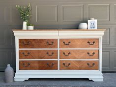 an old dresser has been painted white and brown