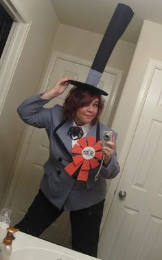 a woman is taking a selfie in the mirror wearing a hat and holding a cell phone