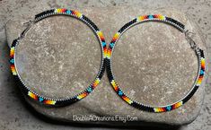 Here's a pair of Black with Native Colors hoop earrings that are lightweight and comfortable to wear all day long. Made with high quality glass Delica Beads, beaded one bead at a time.  Love and passion goes into making my jewelry. This process requires focus, patience and dedication. Each bead is 16th of an inch and can take hours to complete a project. These hoops are 3" wide around. They would be a great addition to your wardrobe.  You will receive many compliments. These hoops would be a gre Bead Hoop Earrings, Delica Beads, Beaded Jewelry Diy, Beaded Earrings