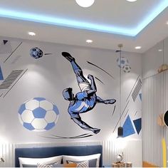 a bedroom with a soccer mural on the wall and a bed in front of it