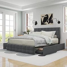 a large bed sitting on top of a hard wood floor next to a white wall