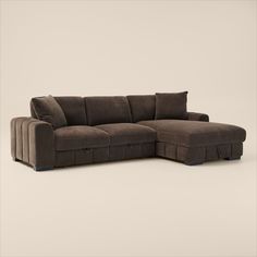 a brown sectional sofa sitting on top of a white floor