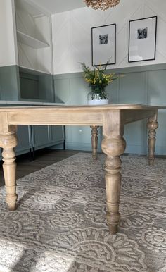 a wooden table sitting on top of a rug