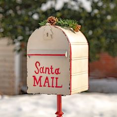 a mailbox with a pine cone on top that says santa mail in red lettering