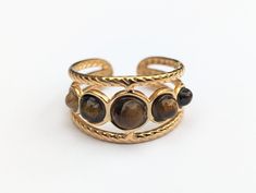 💍Adjustable Tigers Eye Gemstone Ring💍 💎This mystical and deep brown Tigers Eye gemstone ring has an open back so it can be adjusted by you to fit your finger. This ring is made with 18k Gold Plated Stainless Steel to ensure that it never rusts, tarnishes, discolors or corrodes! 🔥More Information: 🔥Size - Adjustable 🔥Metal - 18K Gold Plated Stainless Steel Tigers Eye Ring, Brown Tiger Eye, Men Rings, Tigers Eye Gemstone, 18k Gold Ring, Eye Ring, Unisex Ring, Deep Brown, Tigers Eye