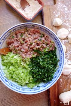 a bowl filled with meat and vegetables on top of a wooden table