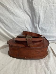 "Measurements are 13\" wide, 10\"5 high, 3\"4 deep with a 54\" shoulder strap at it's longest with a 24\"5 drop. On the interior there is one main compartment with 2 back zipper pocket, two back pockets, lined in twill fabric and a front pocket under flap closure. Leather is lightly oil waxed with brass tone hardware and one exterior pocket for easy access. The leather is strong with no tears and bag can be used crossbody. This bag is great for work,school and daily use. ------------------------ Oiled Leather Crossbody Shoulder Bag With Leather Lining, Crossbody Shoulder Bag With Oiled Leather And Leather Lining, Crossbody Shoulder Bag With Oiled Leather, Oiled Leather Shoulder Bag With Leather Lining, Crossbody Oiled Leather Shoulder Bag With Leather Lining, Waxed Finish Satchel Shoulder Bag For School, School Satchel With Waxed Leather Finish, Leather Lined Saddle Flap Bag, Oiled Leather Crossbody Shoulder Bag For Daily Use