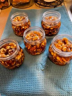 several jars filled with food sitting on top of a blue mat