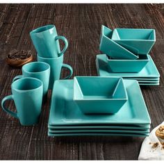 a table topped with blue dishes and cups