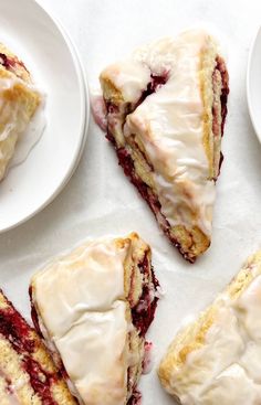 several slices of berry scones on white plates