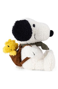 two stuffed animals sitting next to each other in front of a white background and one is holding a yellow teddy bear