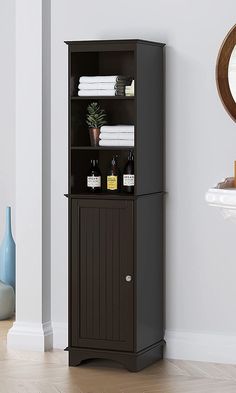 a bathroom with a cabinet and mirror on the wall