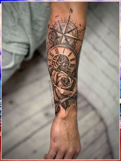 a man's arm with a rose and compass tattoo on it