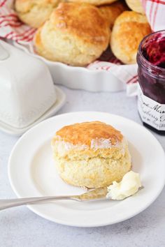 biscuits and jam on a plate with a spoon