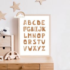 a wooden table topped with a framed poster next to a toy car and star decorations