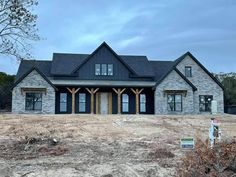 a large house sitting on top of a dry grass field