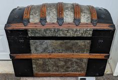 an old trunk is sitting in front of a door