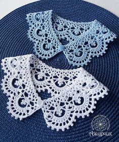 three pieces of crocheted doily sitting on top of a blue place mat