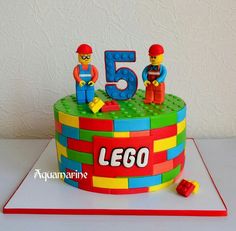 a birthday cake made to look like legos with the number five on it and two men