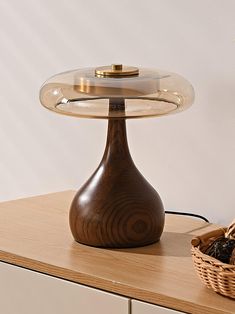 a wooden table with a glass dome on top