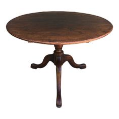 an old fashioned wooden table with two legs and a round top, on a white background