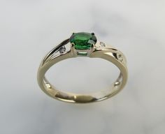 "A deep green lively Tsavorite garnet gemstone elegantly tops this platinum diamond band. The .47 carat green gemstone was newly set into this vintage 1970s very light yellow to white gold setting. The gemstone was certified and comes with the attached gemological report. The oval mixed-cut garnet measures approx. 5.14mm x 3.04mm x 2.83mm. It has vibrant intense color, sparkle, nice translucency. Four sturdy thick prongs hold it in place above a shallow gallery setting. There are two 0.6mm round Diamond Accent Ring, Garnet Gem, Masonic Ring, Tsavorite Garnet, 14k White Gold Ring, Green Gemstones, Garnet Gemstone, Multi Stone Ring, Diamond Band