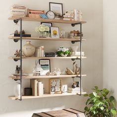 the shelves are filled with books, pictures and vases on top of each shelf