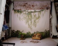 the backdrop is decorated with plants and stuffed animals