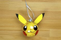 a pokemon pikachu lamp hanging on a wooden floor next to a light bulb