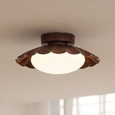 a wooden ceiling light hanging from the ceiling