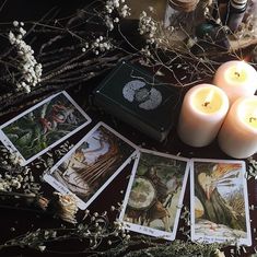 candles and tarot cards on a table